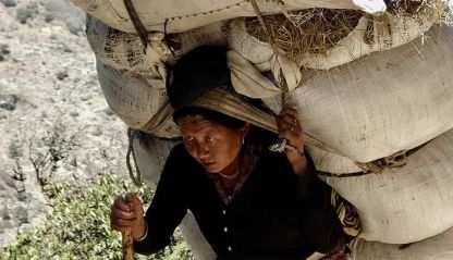 Woman carrying heavy load