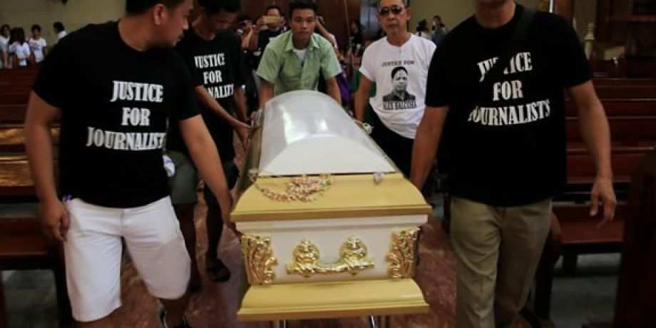 Filipino journalists escort the coffin of slain news reporter Alex Balcoba during his funeral in metro Manila, Philippines June 1, 2016.