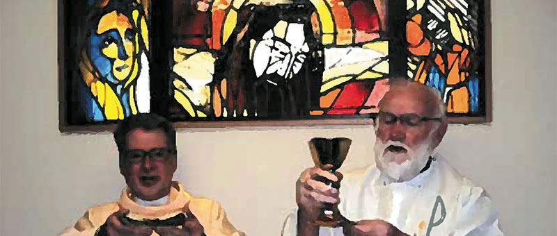 Columban Frs. Barry Cairns (right) and Leo Schumaker (left) in front of the window