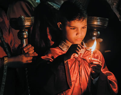 Child lighting a candle