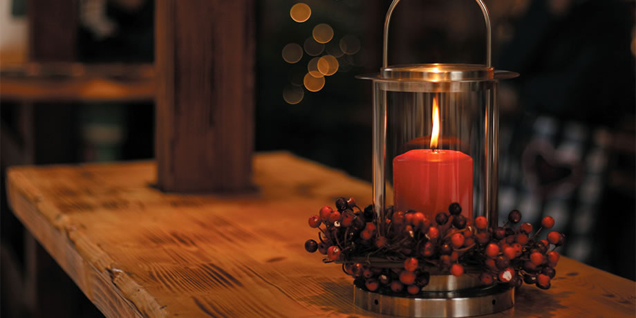 A lighted candle on a table