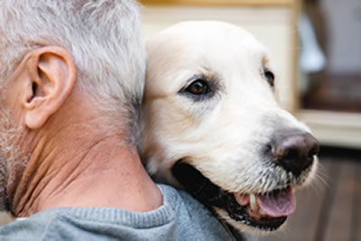 Man hugging dog