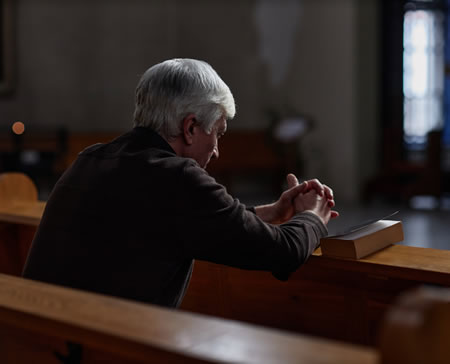 Person praying in a church