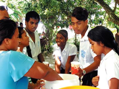 Students line up for juice at Santa Maria College, Tarawa