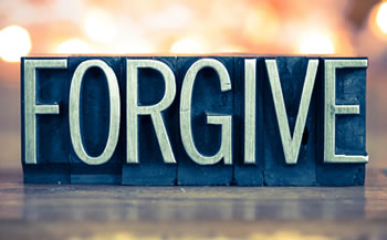 Forgive spelled out on a desk