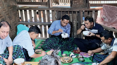 Michael with the fathers' group sharing a meal after the prayer service