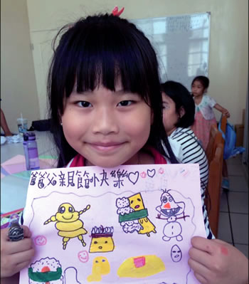 Young girl holding her drawing
