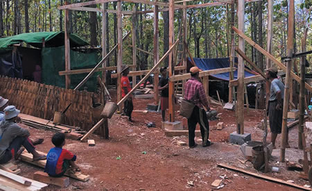 Villagers construct classrooms in the jungle
