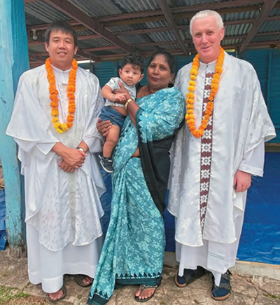 Mother and son with Fr. Carlo (left) and Fr. Tim