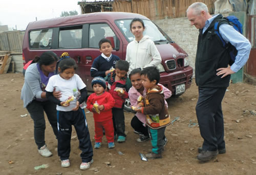 Fr. John Boles with a local family