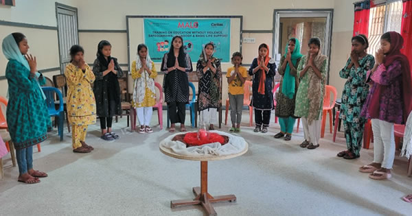 Women standing in a semicircle meditating
