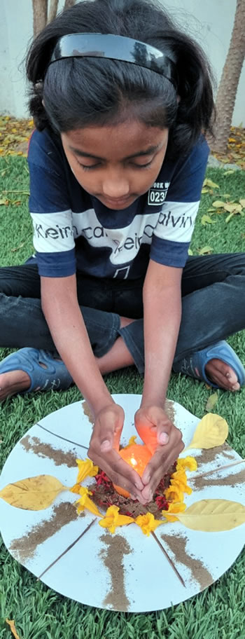A girl lighting a candle