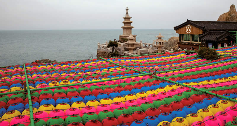 Colorful lanters stretch across the grounds overlooking water