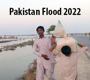 Boy carries bag of flour surrounded by flood water