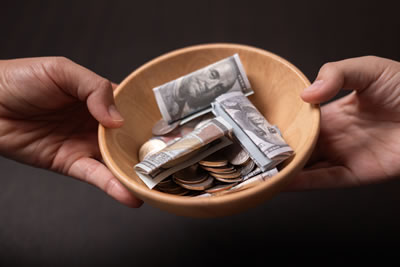 hands holding a donation plate