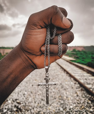 A hand holding a rosary