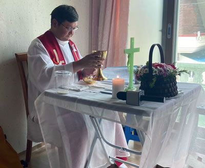 Fr. Borquez at a home Mass