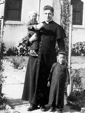 Columban Fr. William Holland and two children