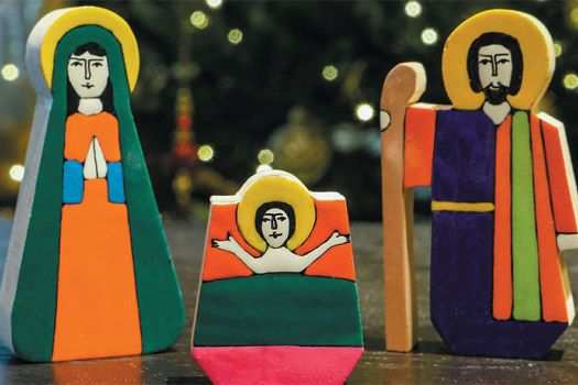 Wooden block figures of the Holy Family on a table