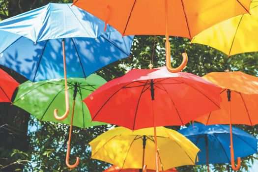 Colorful umbrellas float in the air