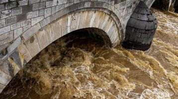 Rushing water under a bridge