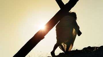 Jesus carrying the cross up a hill