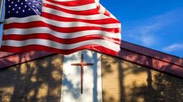 American Flag flying in front of a church