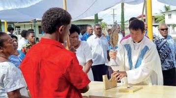 Columban Fr. Carlo Jung Euikyun with parishioners during the Corpus Christi Sunday procession