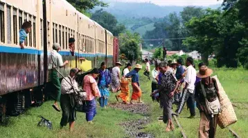 Refugees step off a train in Myanmar
