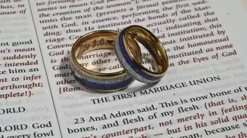Two wedding rings on an open bible
