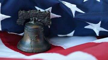 The Liberty Bell setting on an American Flag