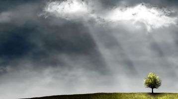 sun shines through stormy clouds