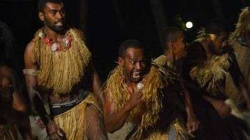 Fijian men dancing a traditional male dance meke wesi the spear dance.
