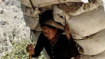 Woman carrying heavy load