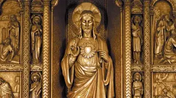 A golden statue of The Sacred Heart of Jesus