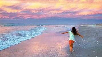 A young girl running on the beach
