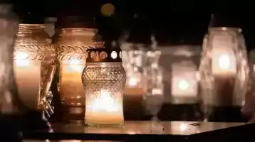 candles burn in a memorial to the deceased