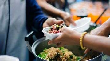 Volunteers feed refugees and migrants.