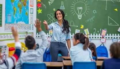 A teacher in front of her class pointing at a student