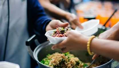 Volunteers feed refugees and migrants.