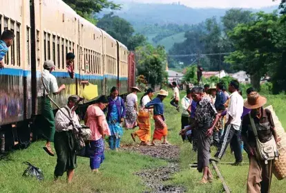 Refugees step off a train in Myanmar