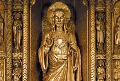 A golden statue of The Sacred Heart of Jesus