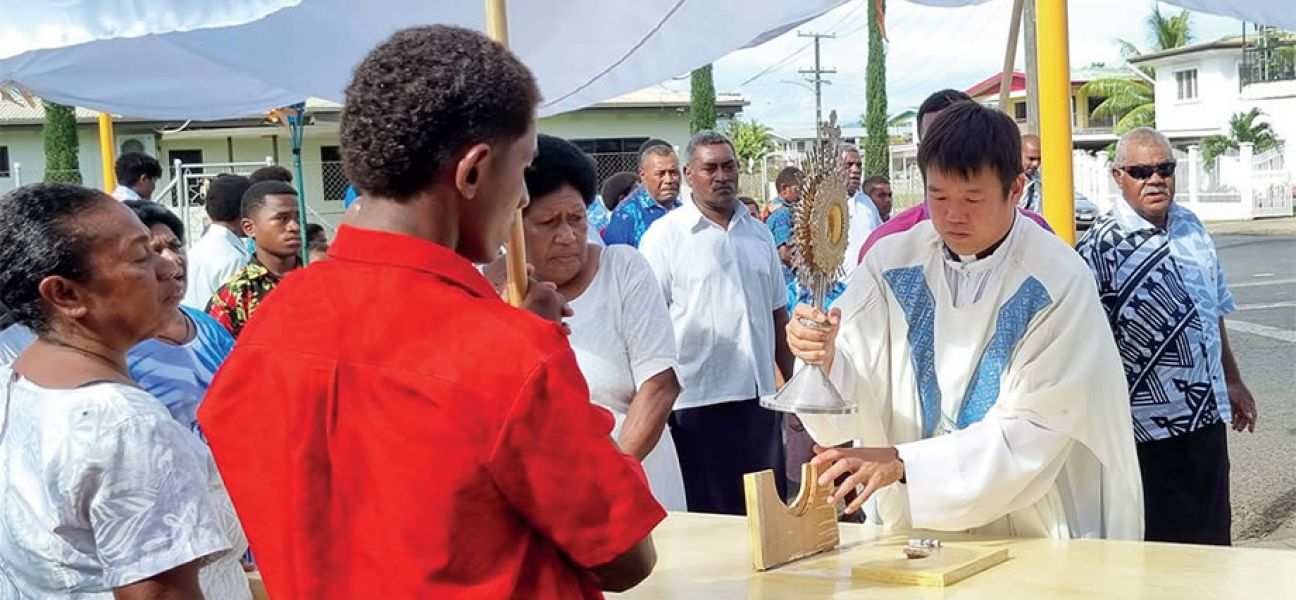 Columban Fr. Carlo Jung Euikyun with parishioners during the Corpus Christi Sunday procession