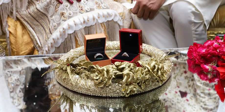 Rings sit on a table in preparations for the Pakistani couple's wedding.