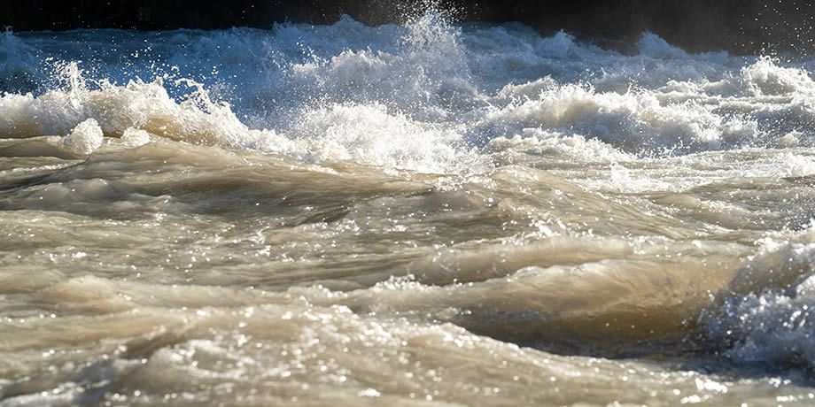 A raging river splashing water