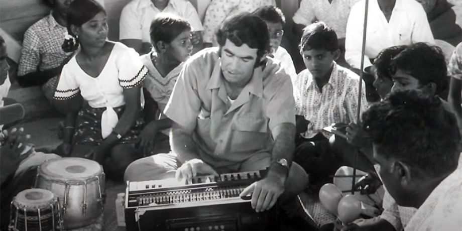 Columban Fr. Frank Hoare playing music and singing with school children