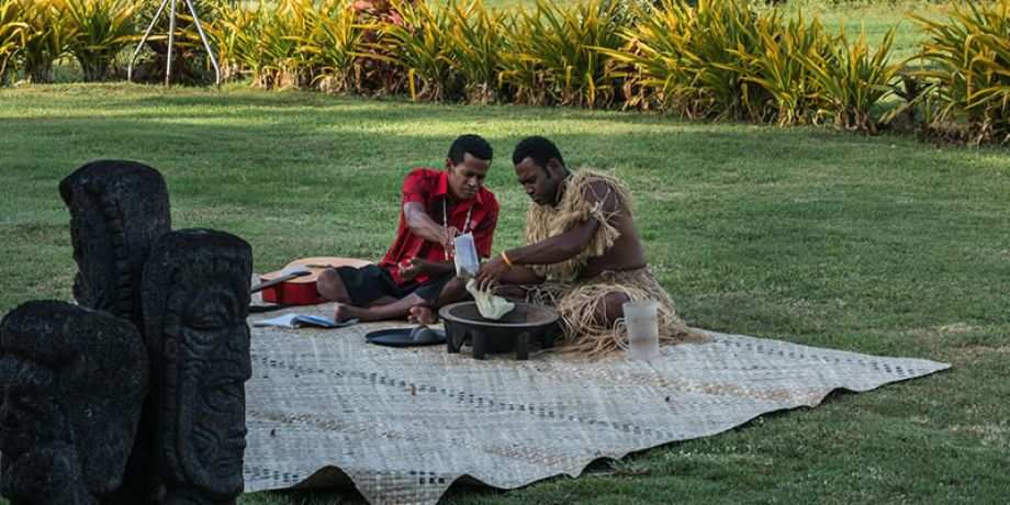 Two people perform the Sevusevu (kava making) ceremony