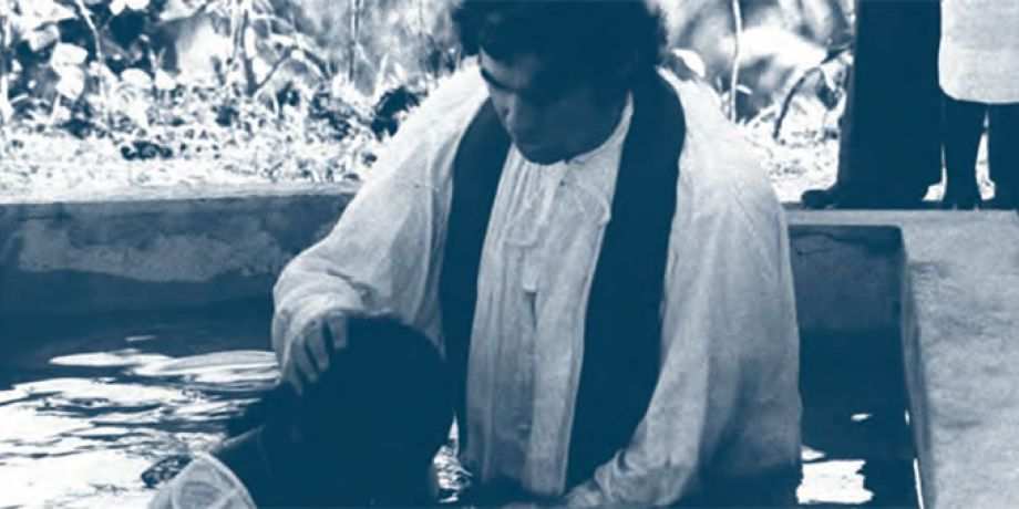 Fr. Frank Hoare baptizing by immersion, 1976