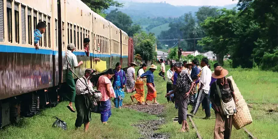 Refugees step off a train in Myanmar