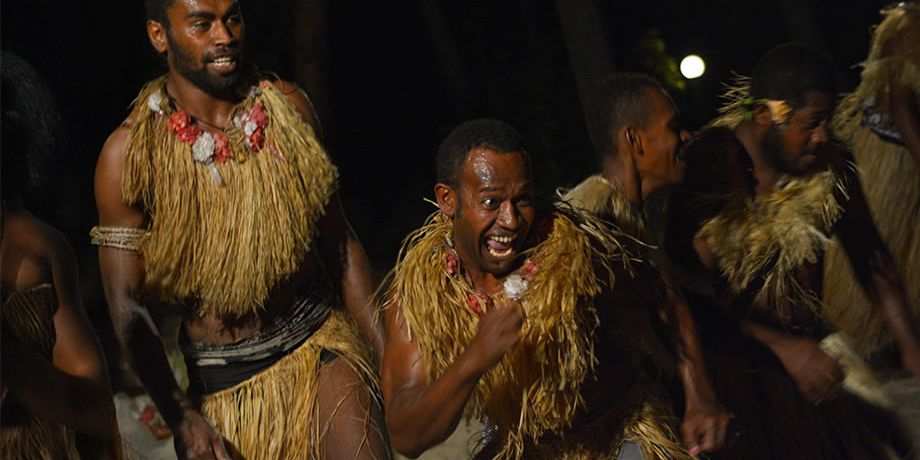 Fijian men dancing a traditional male dance meke wesi the spear dance.